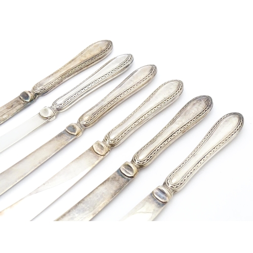 417 - A cased set of six tea / butter knives with silver plate handles, with registered design no. 580513.... 