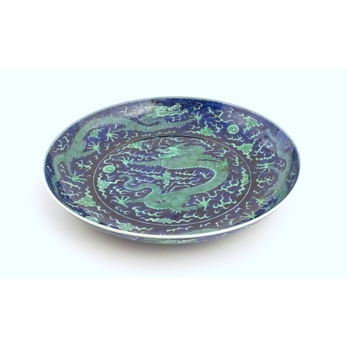 1 - A Chinese charger with a blue ground and green decoration depicting with dragons, flaming pearl and ... 