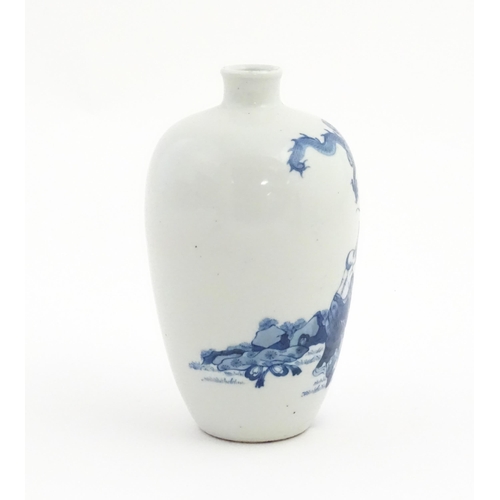 14 - A Chinese blue and white vase decorated with a figure in a landscape scene with a dragon amongst clo... 