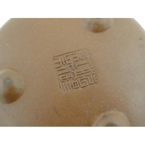 52 - A Chinese Yixing teapot with incised tree and script detail. Character marks under and to underside ... 