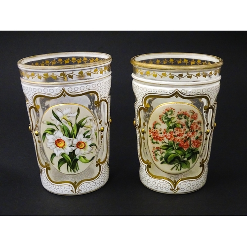 185 - Two 19thC Bohemian glass beakers with white overlay, gilt highlights and hand painted floral sprays.... 