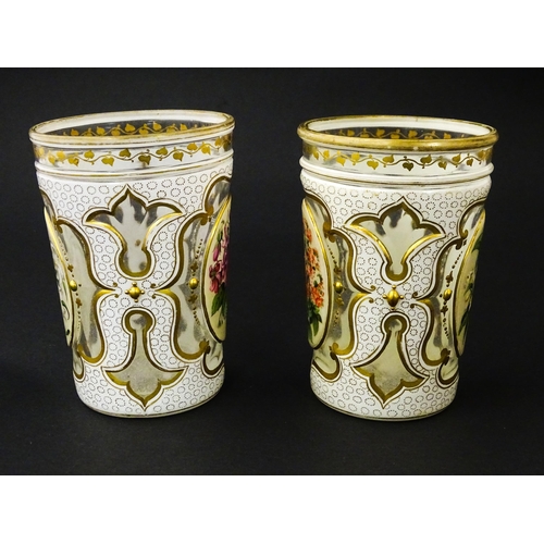 185 - Two 19thC Bohemian glass beakers with white overlay, gilt highlights and hand painted floral sprays.... 