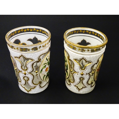 185 - Two 19thC Bohemian glass beakers with white overlay, gilt highlights and hand painted floral sprays.... 