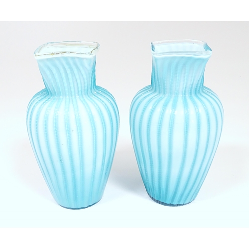 197 - Two turquoise trailed glass vases. Approx 9 1/4