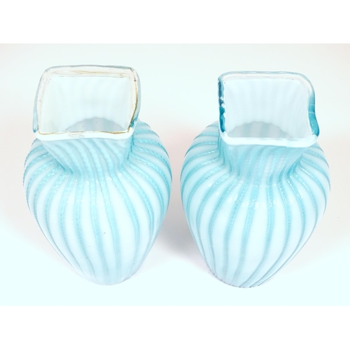 197 - Two turquoise trailed glass vases. Approx 9 1/4