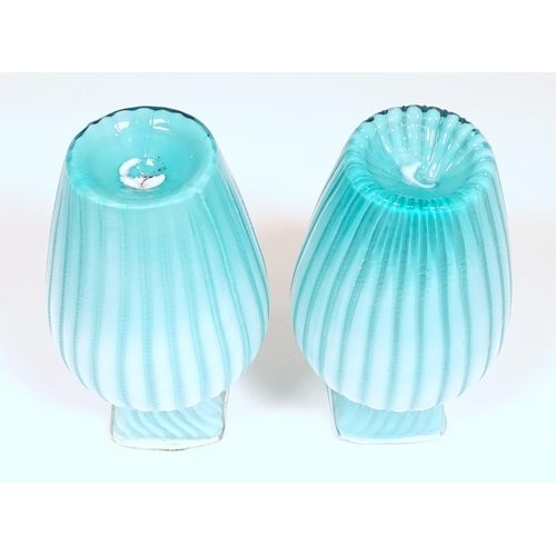 197 - Two turquoise trailed glass vases. Approx 9 1/4