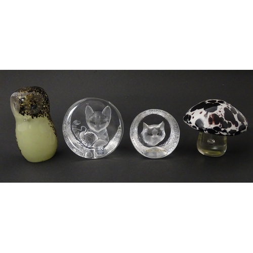 206 - Four 20thC glass paperweights, comprising a Wedgwood owl, two Mats Jonasson cats and a white/purple ... 