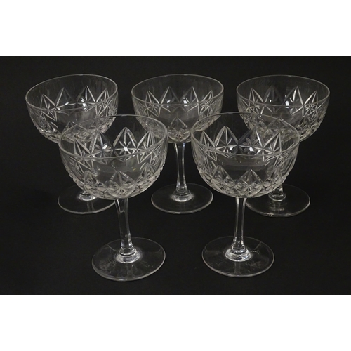 207 - Five cut glass champagne coupes together with five cut glass pedestal wine glasses. Approx 4 1/2