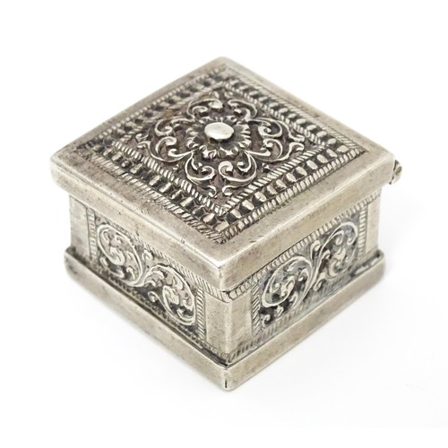 437 - A white metal stamp box with acanthus scroll detail. 1 1/4