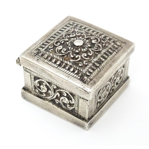 437 - A white metal stamp box with acanthus scroll detail. 1 1/4