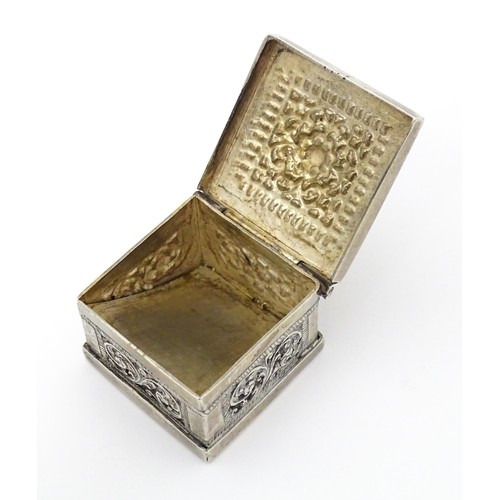 437 - A white metal stamp box with acanthus scroll detail. 1 1/4