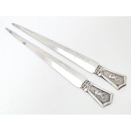 463 - A pair of silver plate letter openers surmounted by lion rampant decoration, maker Roberts & Belk. A... 