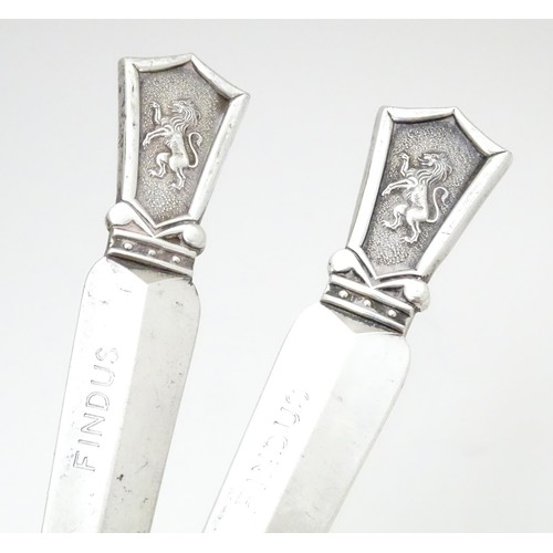 463 - A pair of silver plate letter openers surmounted by lion rampant decoration, maker Roberts & Belk. A... 