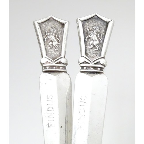 463 - A pair of silver plate letter openers surmounted by lion rampant decoration, maker Roberts & Belk. A... 