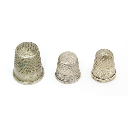 466 - Three thimbles comprising a silver thimble hallmarked Chester 1903, maker Charles Horner, and two si... 