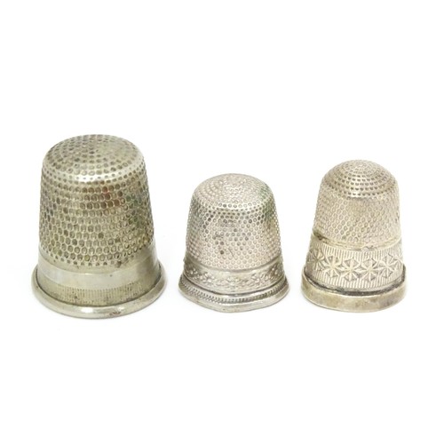 466 - Three thimbles comprising a silver thimble hallmarked Chester 1903, maker Charles Horner, and two si... 