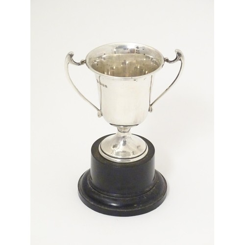 482 - An Art Deco miniature silver twin handled trophy cup with socle base, hallmarked London 1937, maker ... 