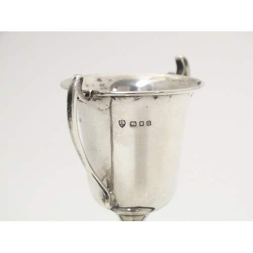 482 - An Art Deco miniature silver twin handled trophy cup with socle base, hallmarked London 1937, maker ... 