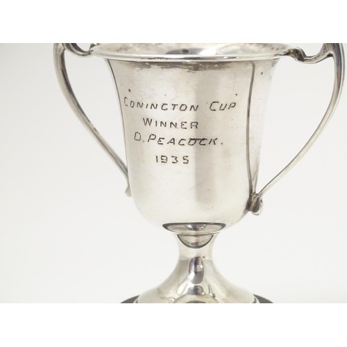 482 - An Art Deco miniature silver twin handled trophy cup with socle base, hallmarked London 1937, maker ... 