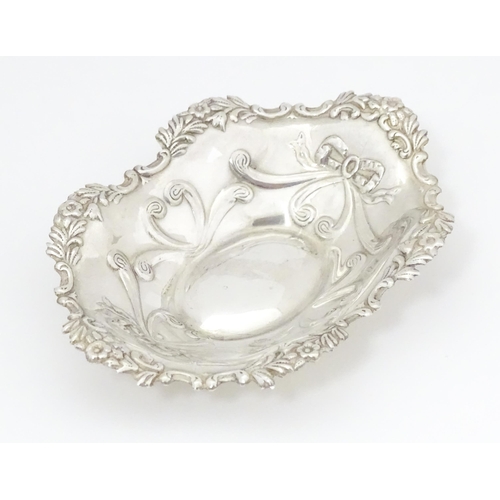 501 - A silver bonbon dish of oval form with embossed decoration, hallmarked Birmingham 2002 with Elizabet... 