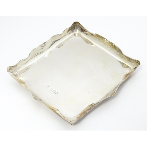 506 - A Victorian silver pin dish of rectangular form raised on four ball feet. Hallmarked London 1895 mak... 