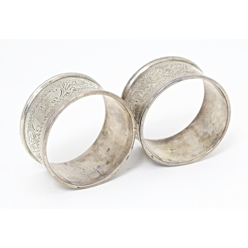 509 - Two silver napkin rings with engraved acanthus scroll decoration, hallmarked Birmingham 1905, maker ... 