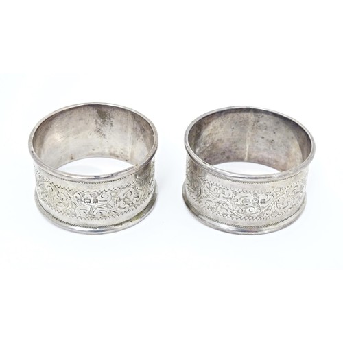 509 - Two silver napkin rings with engraved acanthus scroll decoration, hallmarked Birmingham 1905, maker ... 