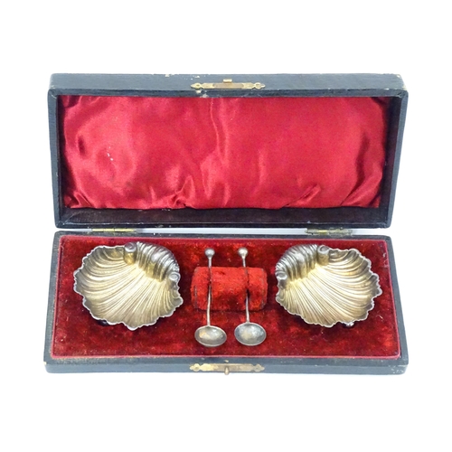 519 - A cased pair of silver salts of scallop shell form, and a pair of silver salt spoons hallmarked Birm... 