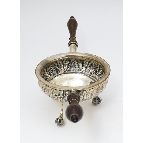 591 - A white metal brazier / ember bowl foliate detail and raised on three ball and claw feet with twin h... 