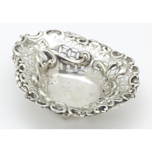 593 - A silver bonbon dish of stylised heart form with pierced and embossed decoration, hallmarked Chester... 