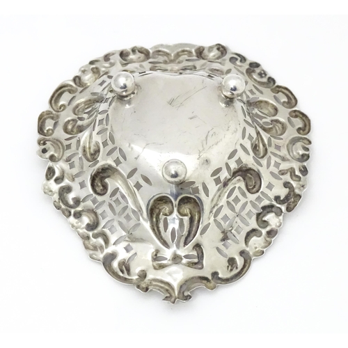 593 - A silver bonbon dish of stylised heart form with pierced and embossed decoration, hallmarked Chester... 