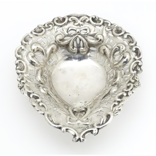 593 - A silver bonbon dish of stylised heart form with pierced and embossed decoration, hallmarked Chester... 