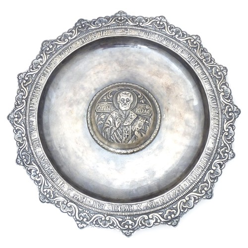 596 - A Greek Orthodox white metal ecclesiastical charger / paten / offertory plate depicting St Nicholas ... 