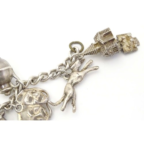 669 - A small white metal and silver plate charm bracelet set with approx 14