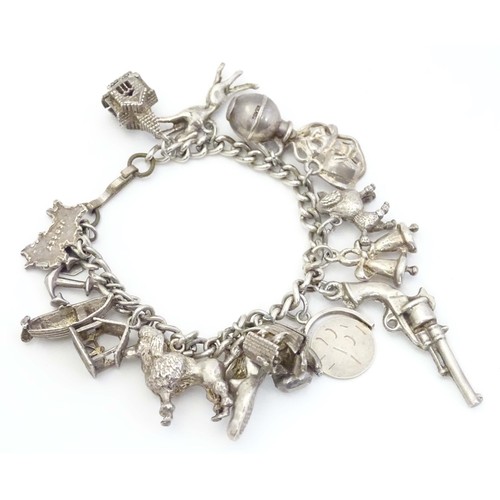 669 - A small white metal and silver plate charm bracelet set with approx 14