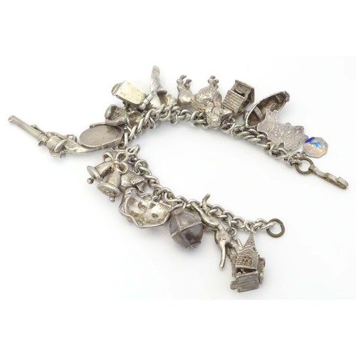 669 - A small white metal and silver plate charm bracelet set with approx 14