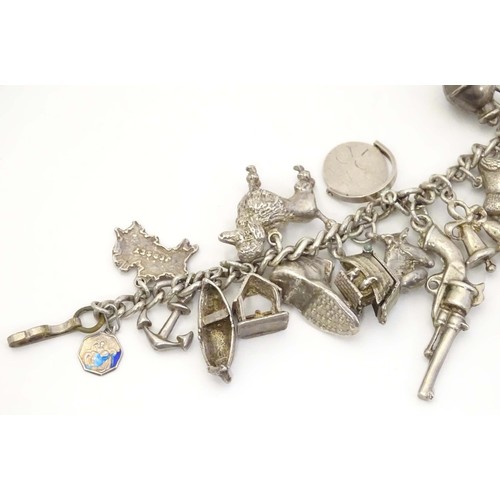 669 - A small white metal and silver plate charm bracelet set with approx 14