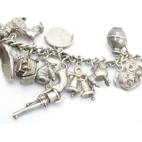 669 - A small white metal and silver plate charm bracelet set with approx 14