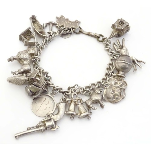 669 - A small white metal and silver plate charm bracelet set with approx 14