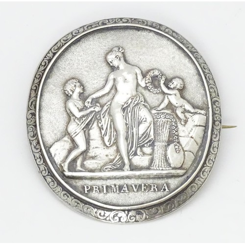 693 - A white metal brooch with Classical scene titled Primavera. Approx. 2 1/2