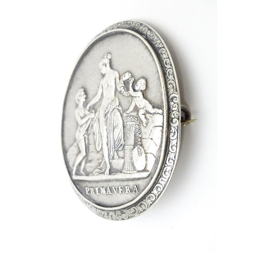 693 - A white metal brooch with Classical scene titled Primavera. Approx. 2 1/2