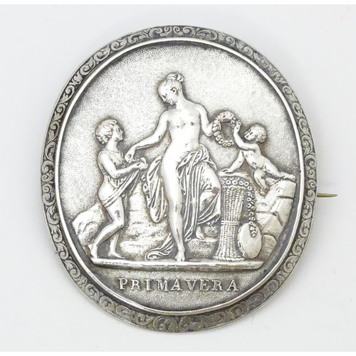 693 - A white metal brooch with Classical scene titled Primavera. Approx. 2 1/2