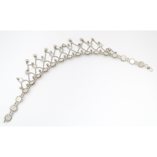 698 - A white metal festoon choker necklace with silver cabochon and bead detail. 15