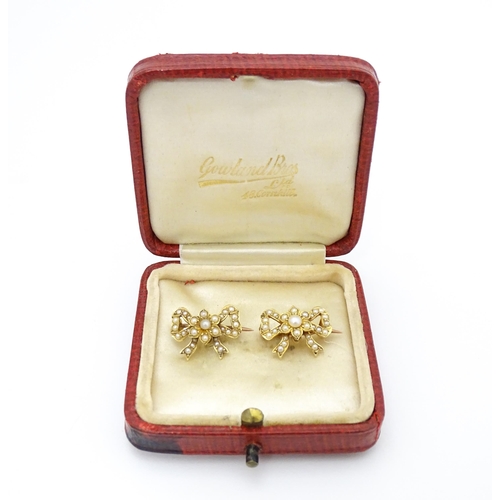 702 - Two Victorian yellow metal brooches of bow form set with seed pearls. Approx 3/4