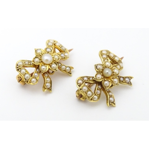 702 - Two Victorian yellow metal brooches of bow form set with seed pearls. Approx 3/4