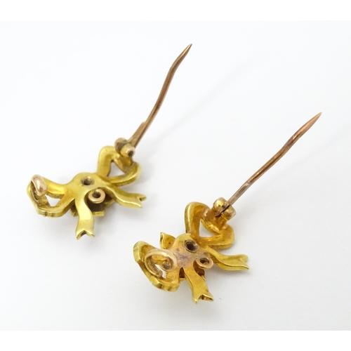 702 - Two Victorian yellow metal brooches of bow form set with seed pearls. Approx 3/4