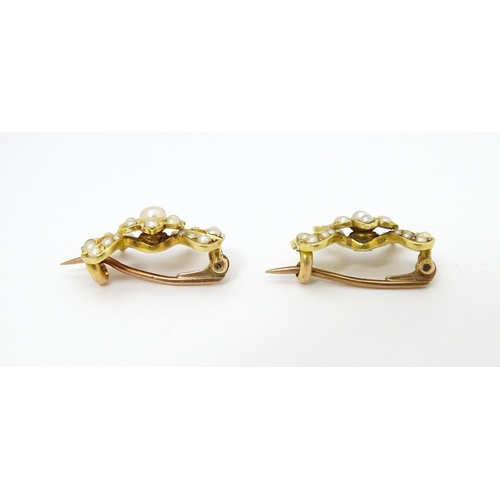 702 - Two Victorian yellow metal brooches of bow form set with seed pearls. Approx 3/4