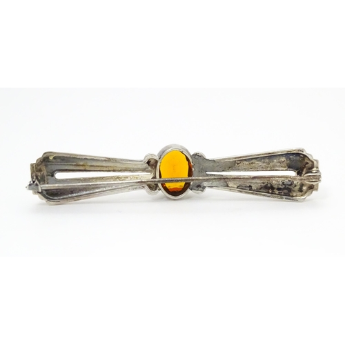 711 - A Continental .835 silver brooch set with central citrine. Indistinctly marked. 2 1/2