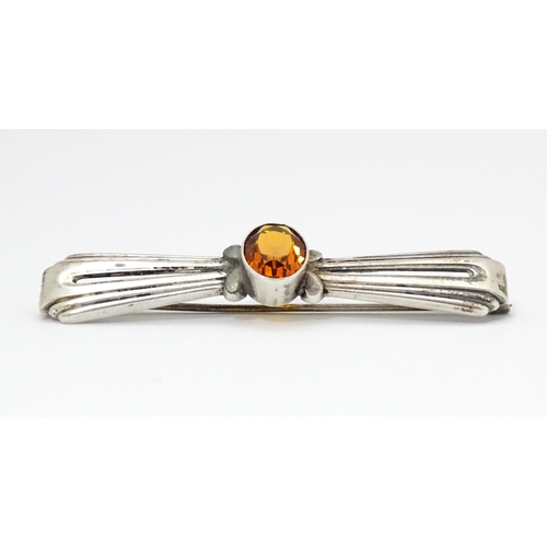 711 - A Continental .835 silver brooch set with central citrine. Indistinctly marked. 2 1/2