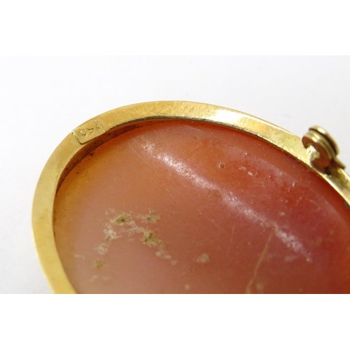 715 - A carved cameo brooch within a gold mount. Approx 1 1/2